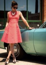 White dress of medium length with red large frequent polka dots