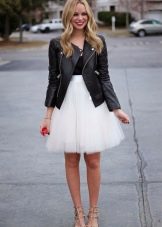 Layered white skirt paired with a black jacket and red stiletto heels