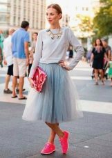 Layered skirt combined with sneakers