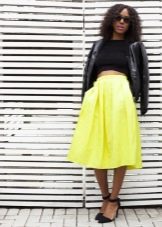 Bright skirt below the knee combined with a dark top