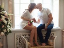 Photoshoot of a pregnant woman with her husband in a photo studio