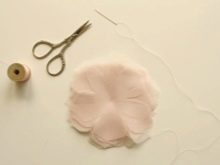 Cutting a flower out of fabric