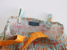 Sewing straps on a dress for a girl