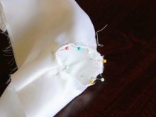 Sewing sleeves to a christening gown
