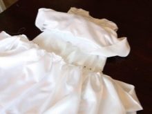 Sewing a skirt to the bodice of a baptismal dress