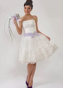 Bride in lace wedding dress with bright bouquet