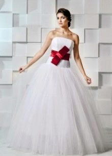 Lush wedding dress with a red bow