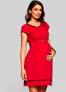 Red maternity dress with black trim on the neckline and bottom of the skirt
