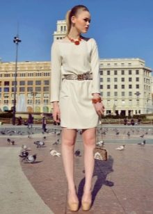 Milk dress paired with bright red jewelry