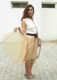 Gonna in organza beige con un paio di décolleté
