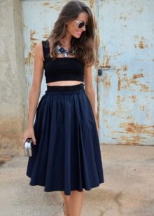 Full skirt below the knee with a short tight top