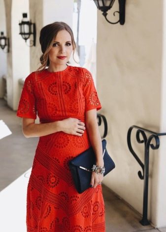 Red maternity dress with black bag