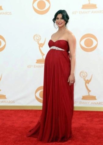 Red empire maternity dress on the floor