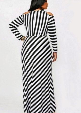 Floor-length striped black and white dress of a simple cut for a plump woman (girl)