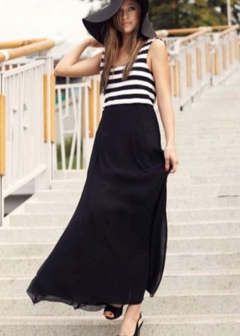 Long semi-sun skirt combined with a striped T-shirt and a hat