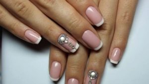 Design ideas for a white jacket on nails with rhinestones