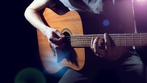 Playing acoustic guitar