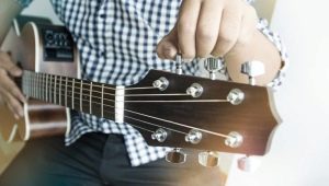 How do I tune my guitar to a tone and semitone lower?
