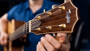 Why does a guitar go out of tune quickly and how is this determined?