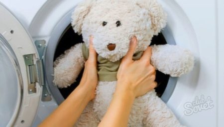 What is the correct way to wash soft toys in the washing machine?