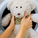 What is the correct way to wash soft toys in the washing machine?