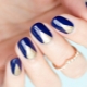 Blue manicure design with gold