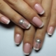 Design ideas for a white jacket on nails with rhinestones
