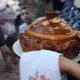 Who takes out and holds a loaf at a wedding?