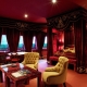 Burgundy curtains in the bedroom interior