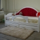 Children's ottoman bed with a soft back: description, types, tips for choosing