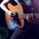 Playing acoustic guitar