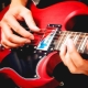 How do I connect an electric guitar to my computer and play it?