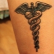 Tattoo in the form of a caduceus symbol