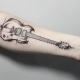 Meaning and sketches of a tattoo in the form of a guitar
