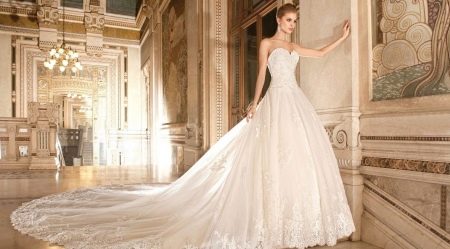 Lush wedding dress with a closed openwork top and a train