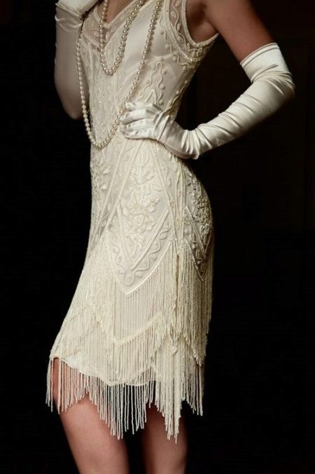 White Gatsby-style asymmetrical dress with gloves and pearls
